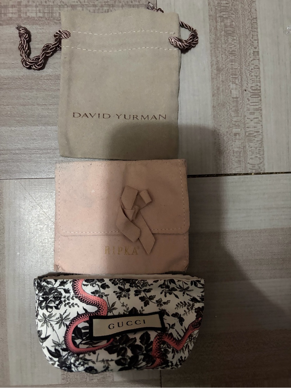 Gucci floral dust bag, David Yurman, Judith RIPKA dust bags.
